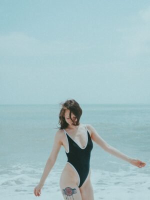Custom one-piece swimsuit with UPF 50+ sun protection fabric, featuring a colorful abstract pattern