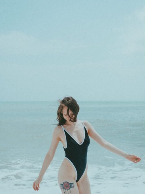 Custom one-piece swimsuit with UPF 50+ sun protection fabric, featuring a colorful abstract pattern