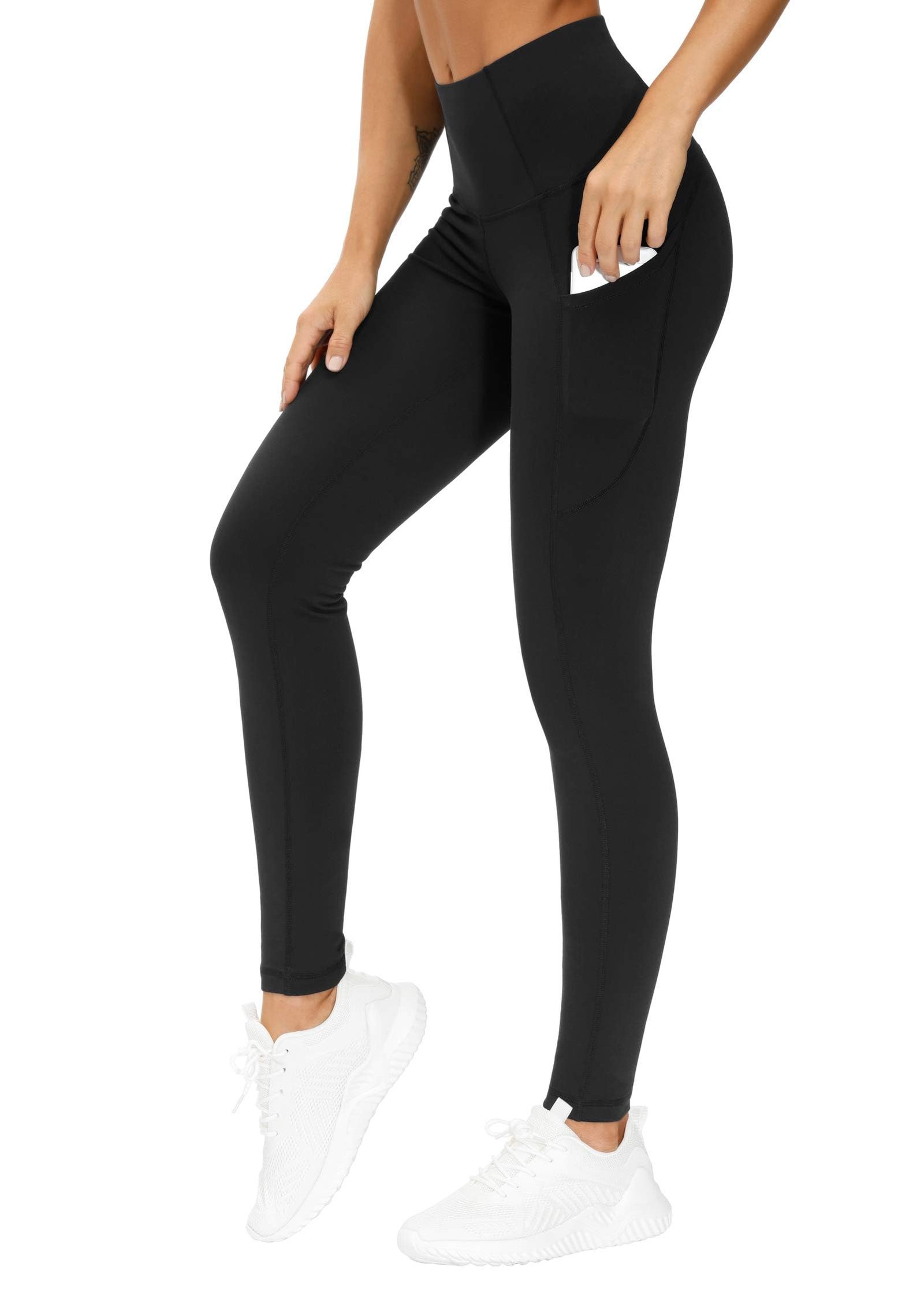 Women's black thick high waist yoga pants with pockets worn by model, tummy control 4-way stretch leggings for yoga running and gym