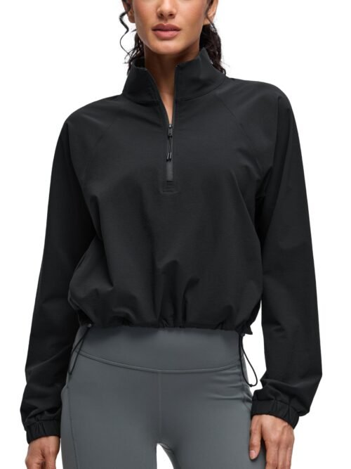Women's black cropped half-zip jacket with stand collar, drawstring hem, elastic cuffs, and front pockets for yoga and outdoor activities