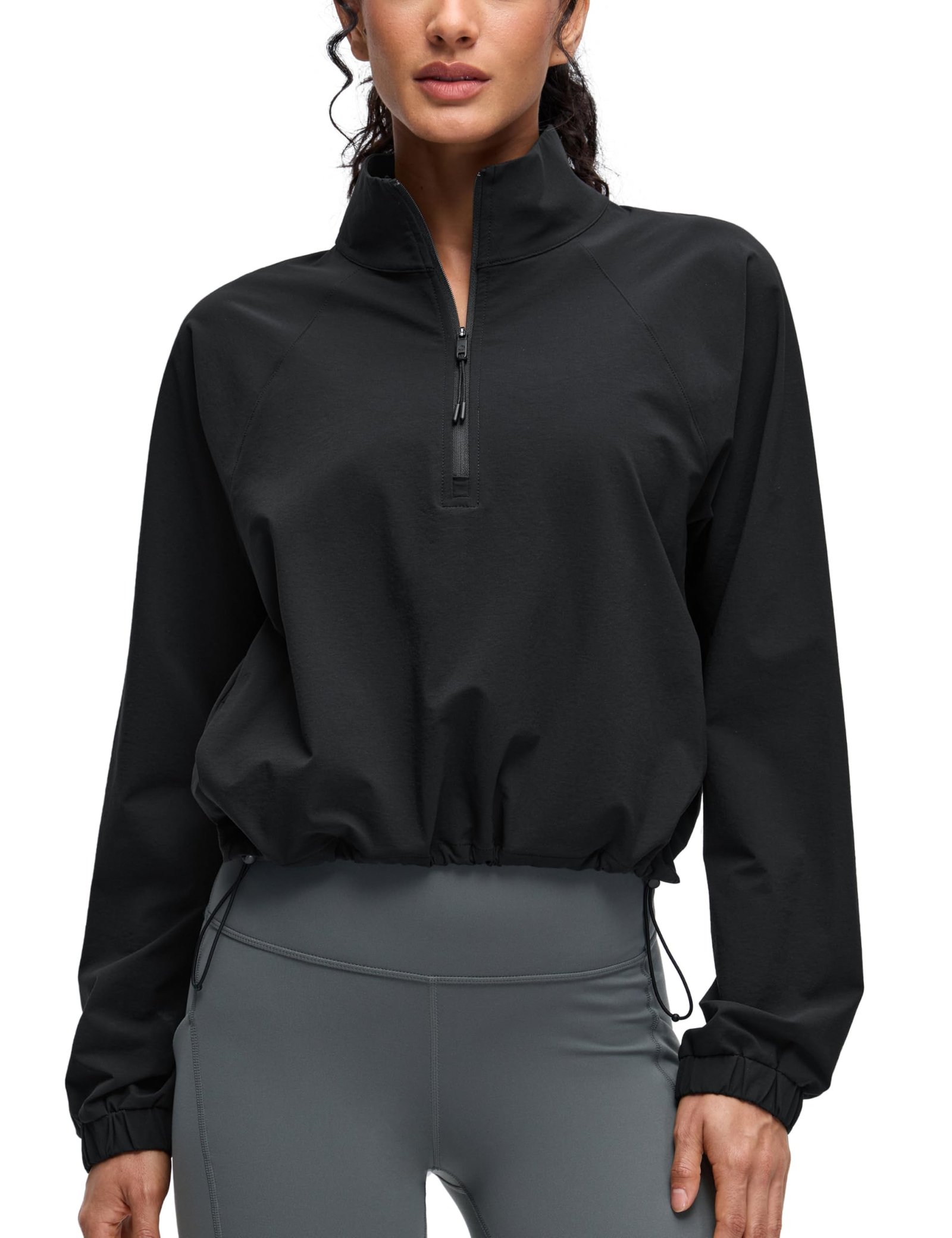 Women's black cropped half-zip jacket with stand collar, drawstring hem, elastic cuffs, and front pockets for yoga and outdoor activities