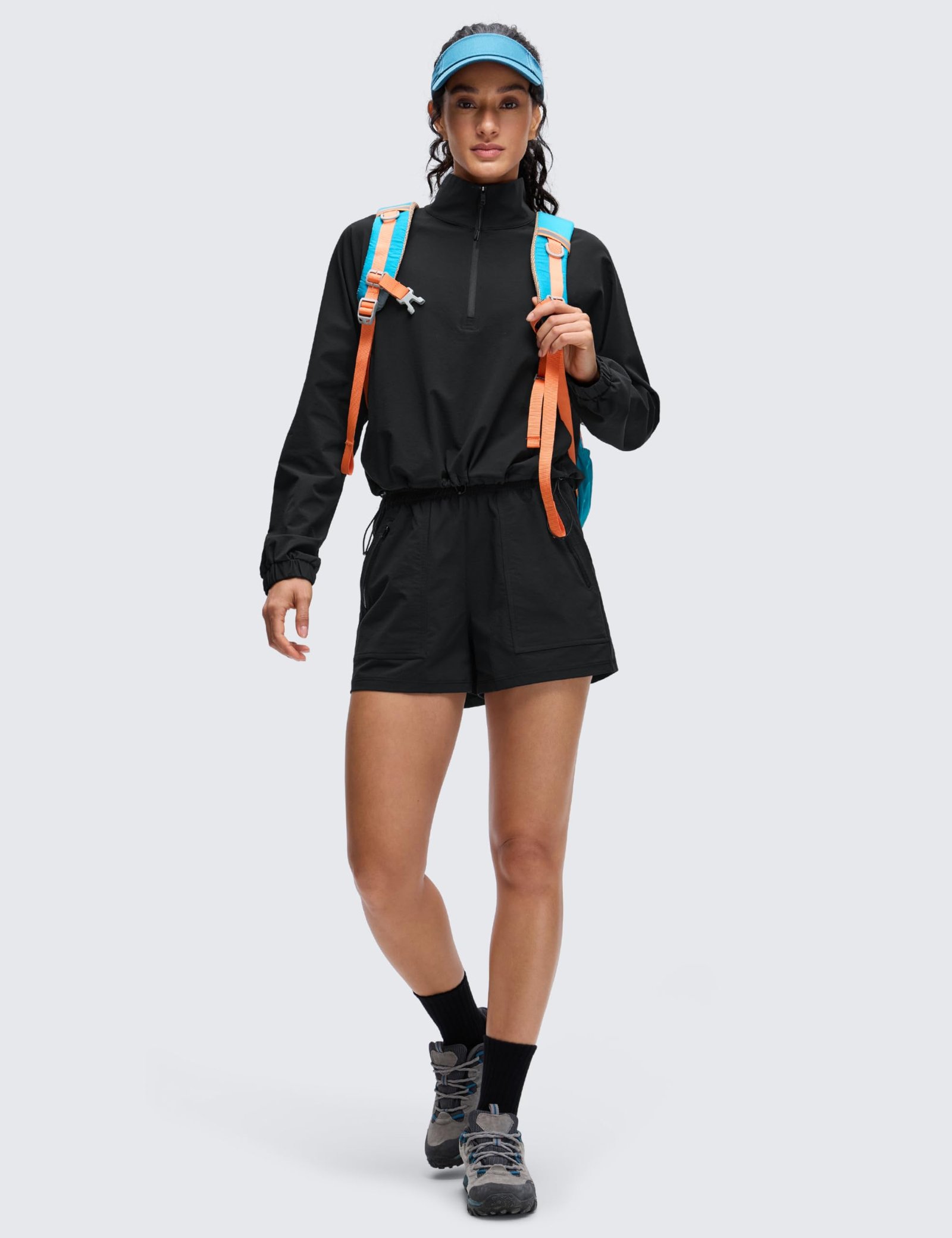 Women's black cropped half-zip jacket with stand collar, drawstring hem, elastic cuffs, and front pockets for yoga and outdoor activities
