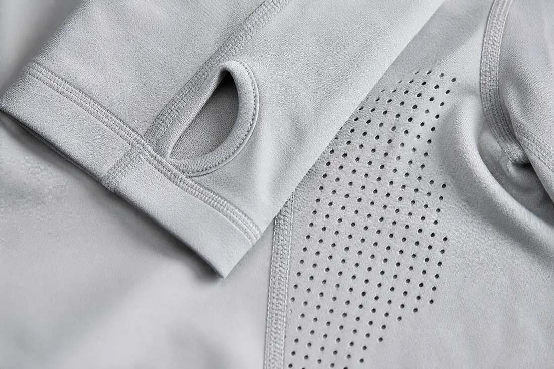 Technical details of custom UPF 50 fishing hoodie showing thumbhole cuffs laser cut ventilation and flatlock seams