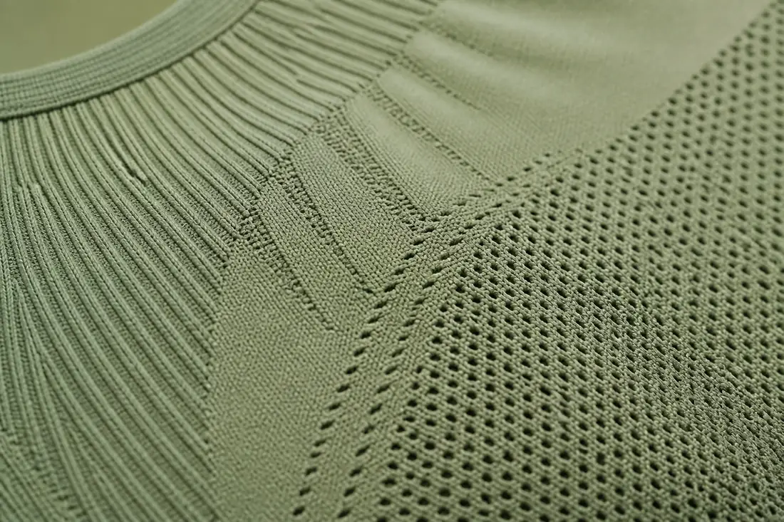 Close up of seamless activewear manufacturer circular knit body mapping compression zones and mesh ventilation